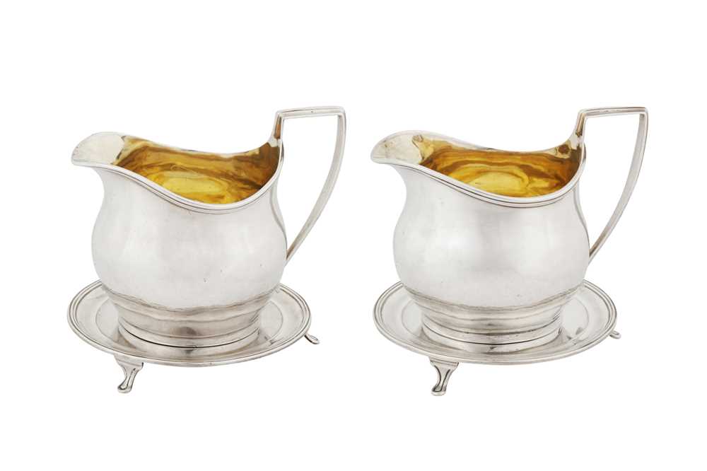 A highly unusual and rare pair of George III provincial sterling silver milk jugs or sauce boats on stands, York 1802 by Hampston, Prince and Cattle