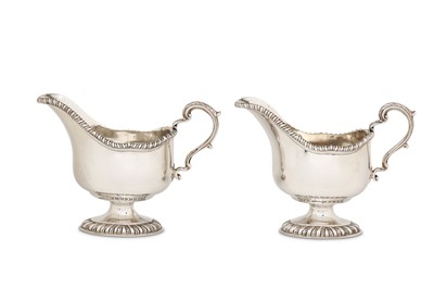 Lot 24 - A pair of George V sterling silver sauceboats,...