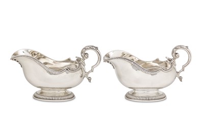 Lot 25 - A pair of George V sterling silver sauceboats,...