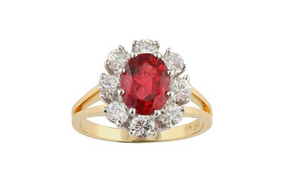 Lot 60 - A spinel and diamond cluster ring The oval-cut...