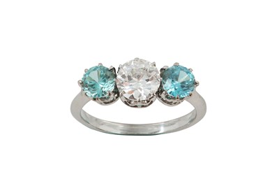 Lot 91 - A diamond and blue zircon three-stone ring,...