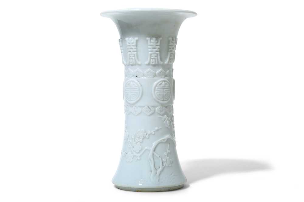 Lot 76 - A CHINESE MOULDED WHITE-GLAZED VASE, GU. Qing...