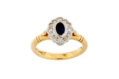 Lot 225 - A sapphire and diamond cluster ring, mounted...