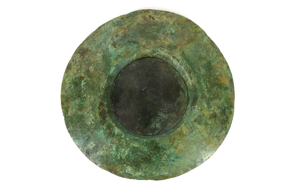 Lot 99 - A WESTERN ASIATIC BRONZE SHIELD FITTING  Circa...