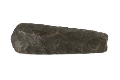 Lot 109 - A NEOLITHIC TRAPEZOIDAL FLINT AXE HEAD Formed...