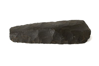 Lot 109 - A NEOLITHIC TRAPEZOIDAL FLINT AXE HEAD Formed...