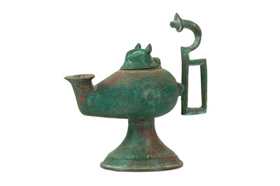 Lot 101 - A FOOTED BRONZE OIL LAMP Iran, 10th - 12th...