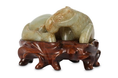 Lot 233 - A CHINESE PALE CELADON CARVING OF A RECUMBENT...