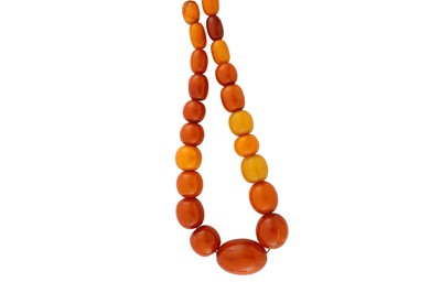 Lot 204 - An amber bead necklace The graduated strand...