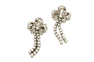 Lot 517 - A pair of diamond earrings Each articulated...