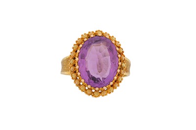 Lot 534 - An amethyst dress ring, 1971 The oval-cut...