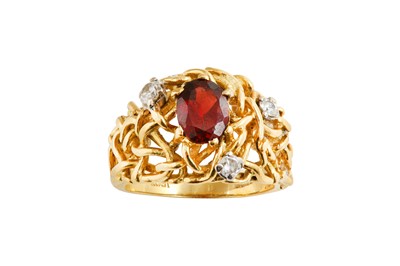 Lot 563 - A garnet and diamond ring The oval-cut garnet,...