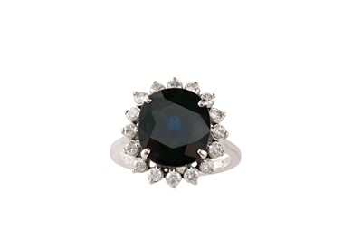 Lot 63 - A sapphire and diamond cluster ring The...