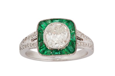 Lot 134 - A diamond and emerald ring The collet-set...