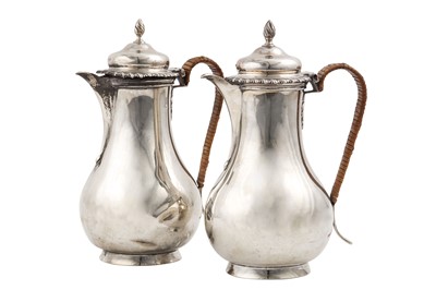 Lot 661 - A pair of George V sterling silver hot water...