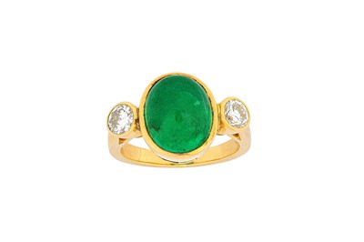 Lot 124 - An emerald and diamond ring The oval cabochon...