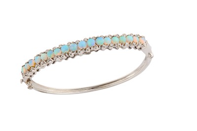 Lot 27 - An opal and diamond bangle The hinged bangle...