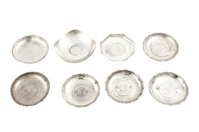 Lot 714 - Eight silver coin or medallion set ashtrays,...