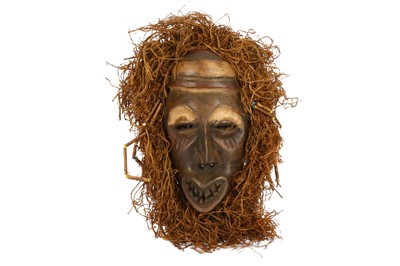 Lot 813 - A FRINGED WOOD MASK The elongated face, with...