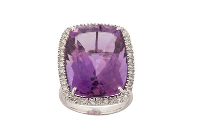 Lot 105 - An amethyst and diamond cluster ring The fancy...