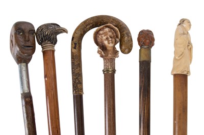 Lot 1012 - Six walking sticks each with carved novelty...