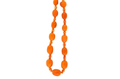 Lot 233 - An amber bead necklace  The single strand of...