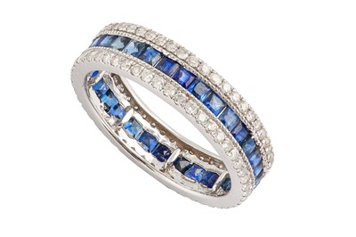 Lot 64 - A sapphire and diamond eternity ring Set with...