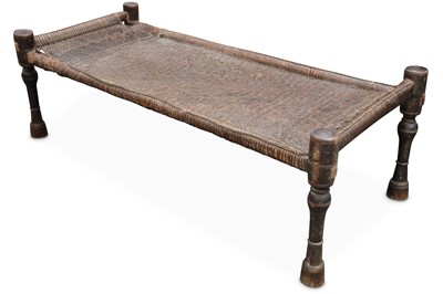 Lot 480 - An Indian hardwood day bed, with rush seat on...