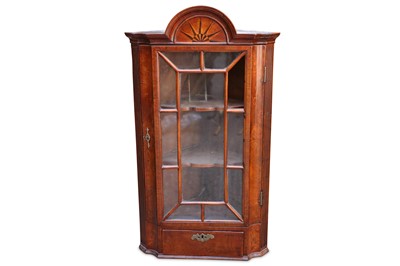 Lot 302 - A Georgian oak hanging corner cupboard, with a...