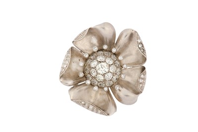 Lot 84 - A diamond flower brooch The central bombé...