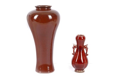 Lot 1033 - TWO CHINESE RED-GLAZED VASES. Late Qing...