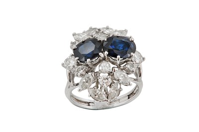 Lot 211 - A sapphire and diamond dress ring The two oval-...