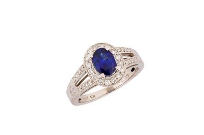 Lot 195 - A sapphire and diamond ring The oval-cut...