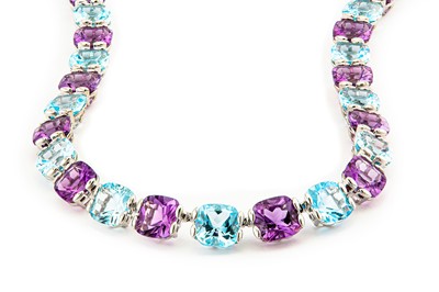 Lot 100 - An amethyst and blue topaz rivière The...