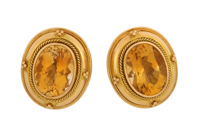 Lot 234 - A pair of citrine earclips Each oval-cut...