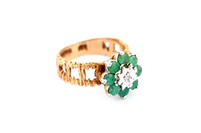 Lot 305 - An emerald and diamond dress ring, 1977, the...