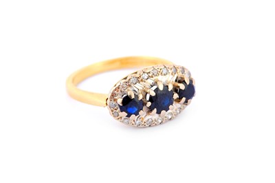 Lot 303 - A sapphire and diamond dress ring, set with...