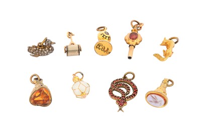Lot 120 - A group of charms, Including three fobs, a...