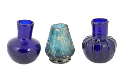 Lot 131 - THREE FREE-BLOWN MONOCHROME GLASS BOTTLES Iran,...