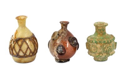 Lot 130 - THREE UMAYYAD HOT-WORKED GLASS BOTTLES Syria,...