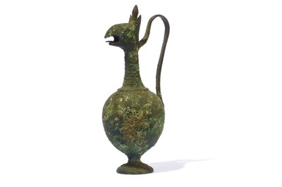 Lot 106 - AN AFTER THE ANTIQUE BRONZE JUGLET Standing on...