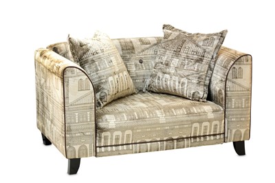 Lot 284 - A modern Fornasetti style snuggler armchair or...