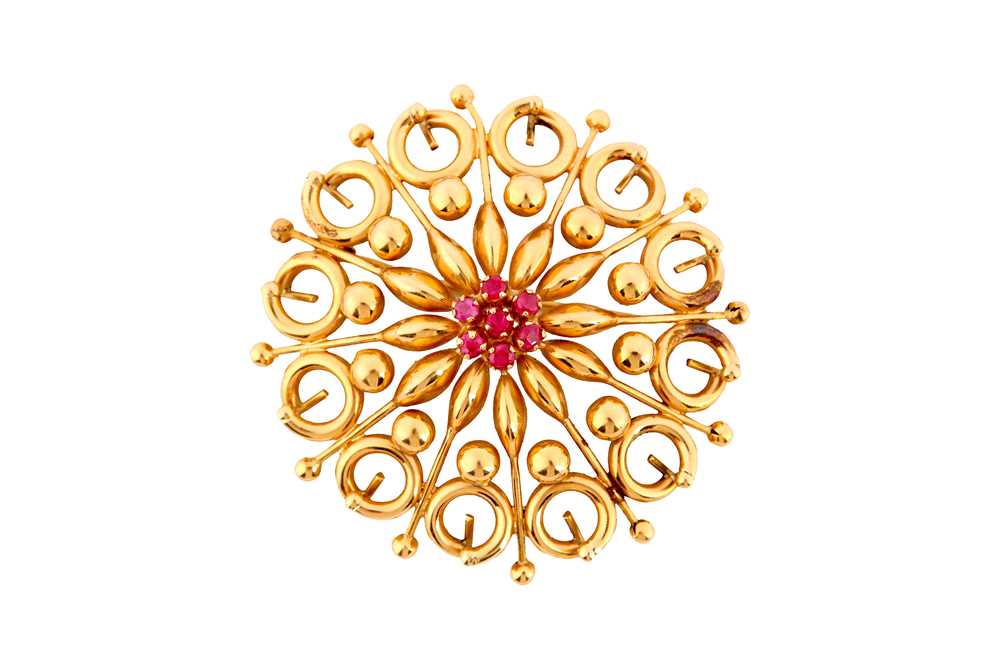 Lot 129 - A ruby brooch, of openwork design, centred by...