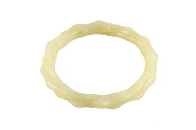 Lot 291 - A Chinese jade 'twisted bamboo' bangle, of...