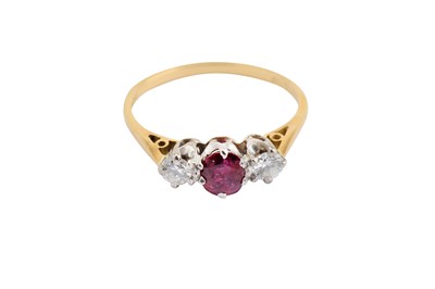 Lot 15 - A ruby and diamond three-stone ring, Mounted...