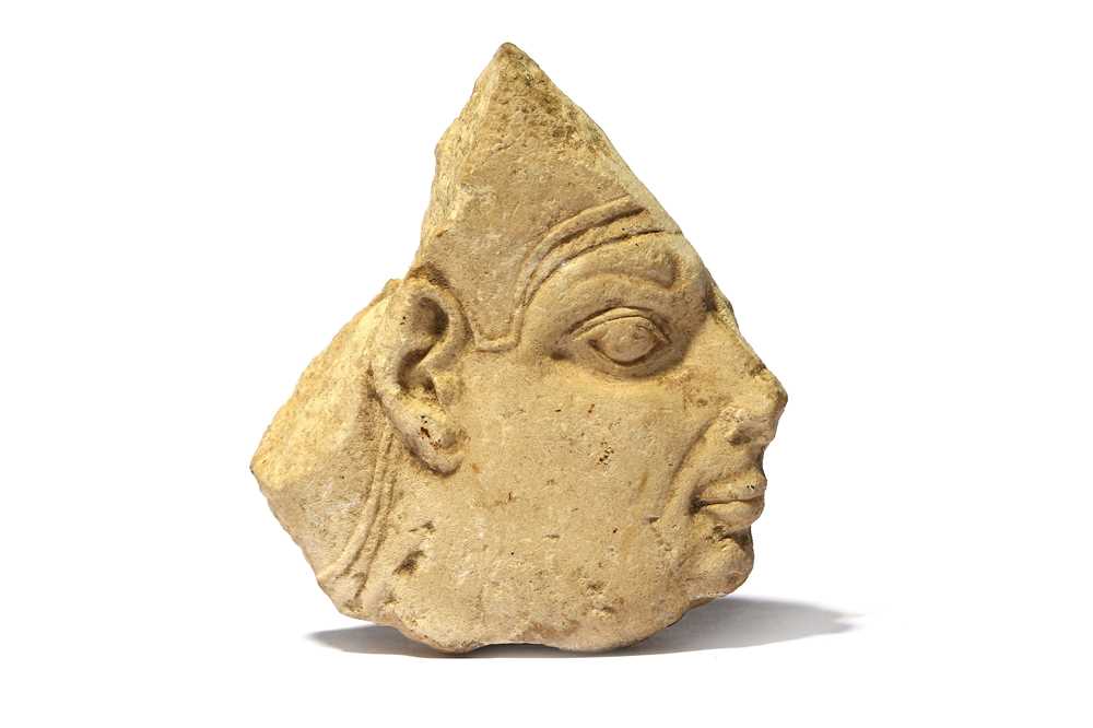 Lot 29 - AN EGYPTIAN LIMESTONE FACE FRAGMENT  Ptolemaic...
