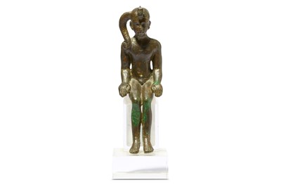 Lot 180 - AN EGYPTIAN SEATED FIGURE OF CHILD HORUS Late...