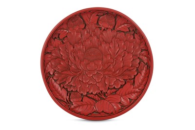Lot 286 - A CINNABAR LACQUER 'PEONY' DISH. Carved to the...