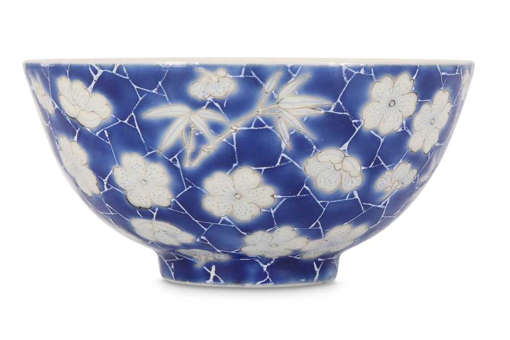 Lot 36 - A SMALL CHINESE BLUE-GROUND 'PRUNUS AND BAMBOO' CUP.