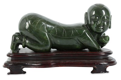 Lot 748 - A CHINESE SPINACH JADE ‘BOY’ PILLOW. The child...